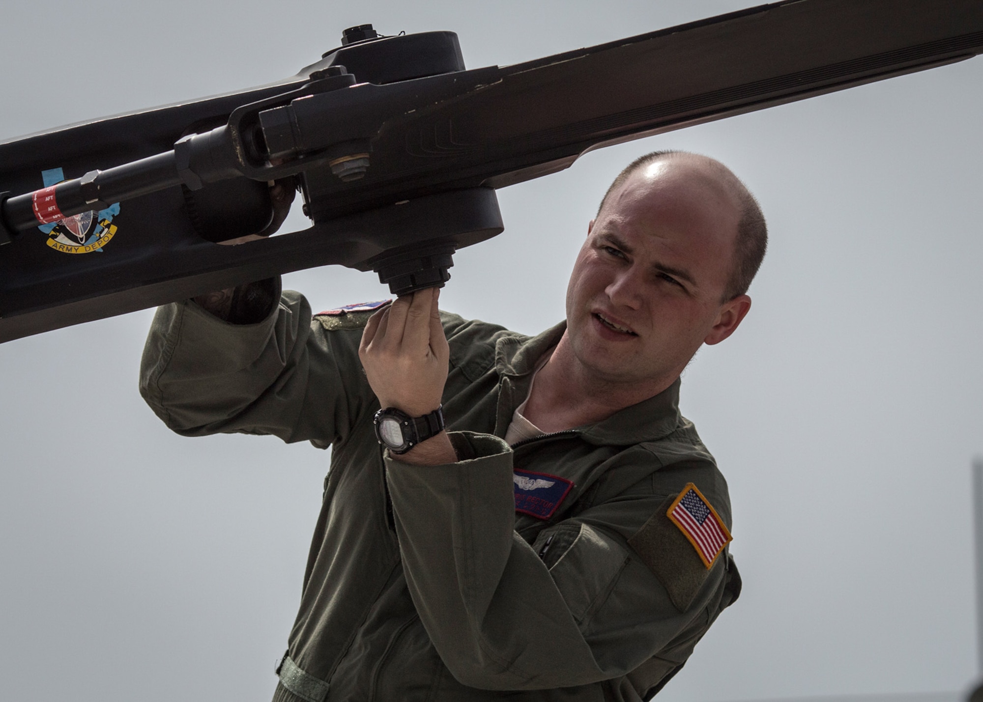 Staff Sgt. Chris Rector, 459th Airlift Squadron flight engineer, performs a pre-flight inspection at Yokota Air Base, Japan, May 8, 2014. The 459th AS performed UH-1N Huey small formation training sorties on May 8 and 9 to improve interoperability. (U.S Air Force photo by 2nd Lt. Ashley Wright/Released)