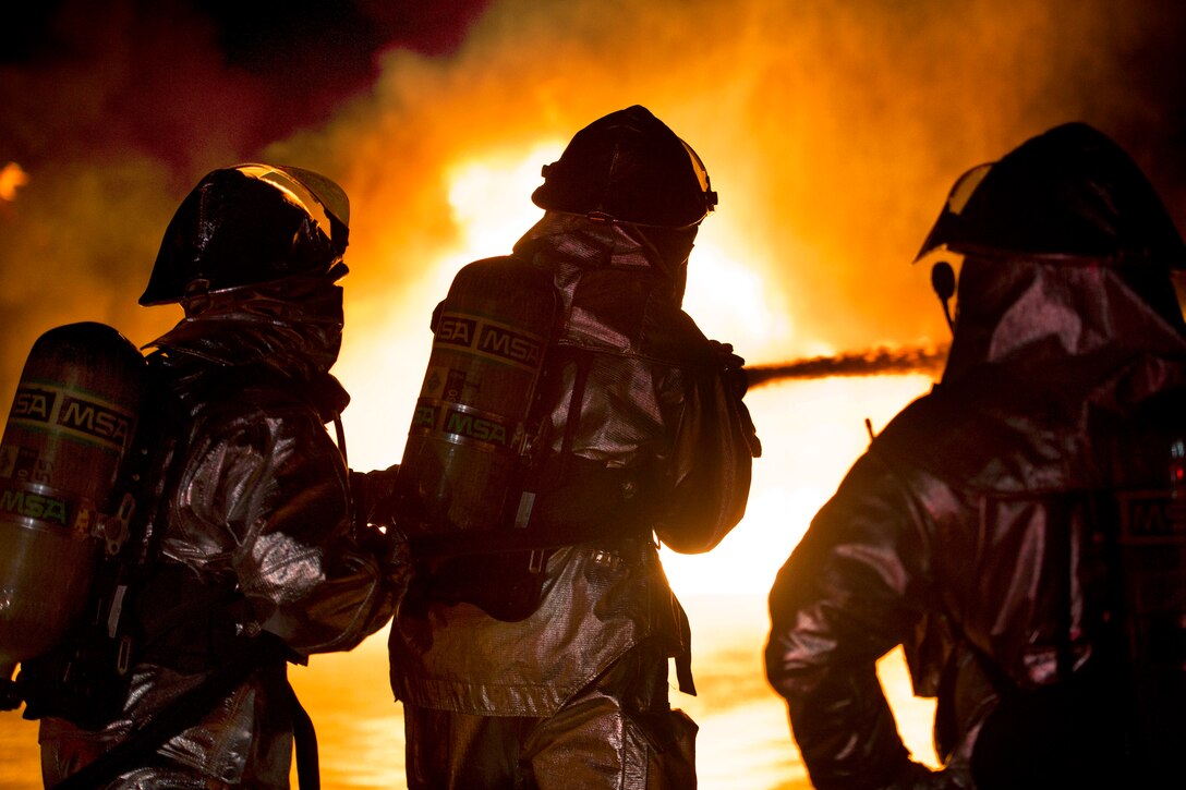 Air Force firefighters suppress a controlled fire during Exercise Patriot Warrior on Fort McCoy, Wis., May 4, 2014.