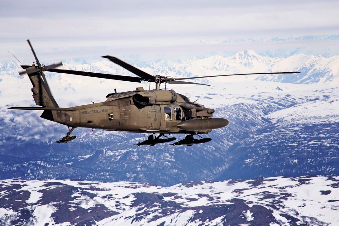 Army Chief Warrant Officer 4 Mike Michaud and Army Chief Warrant Officer 2 Cody McKinney fly a UH-60 Blackhawk helicopter over the Denali National Park during Arctic Pegasus en route to Deadhorse, Alaska, April 30, 2014. The exercise airms to improve the Army's airborne operations, mobility and ground maneuvers in arctic weather conditions. Michaud and McKinney are pilots assigned to the Alaska Army National Guard's 1st Battalion, 207th Aviation Regiment.