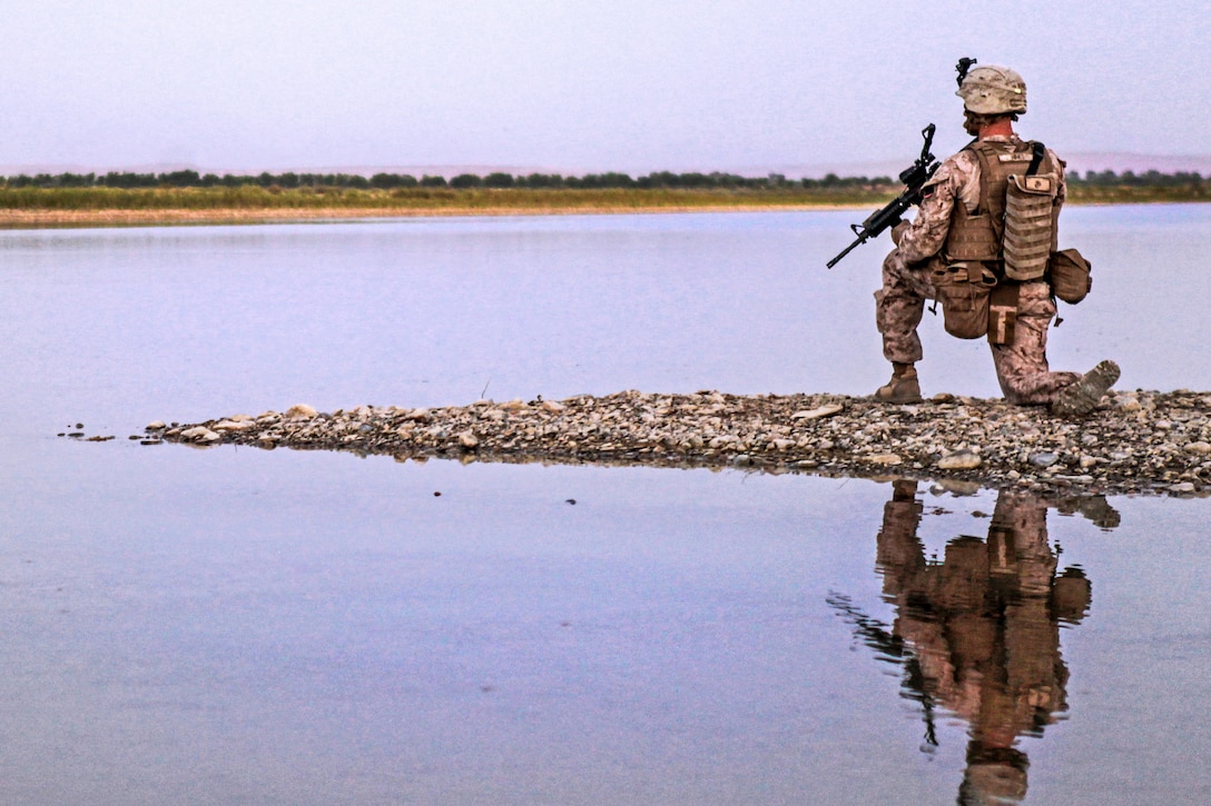 U.S. Marine Corps Cpl. Sean Abrusci provides security during a patrol in Helmand province, Afghanistan, July 5, 2013. Abrusci is assigned to Echo Company, 2nd Battalion, 8th Marine Regiment.  
