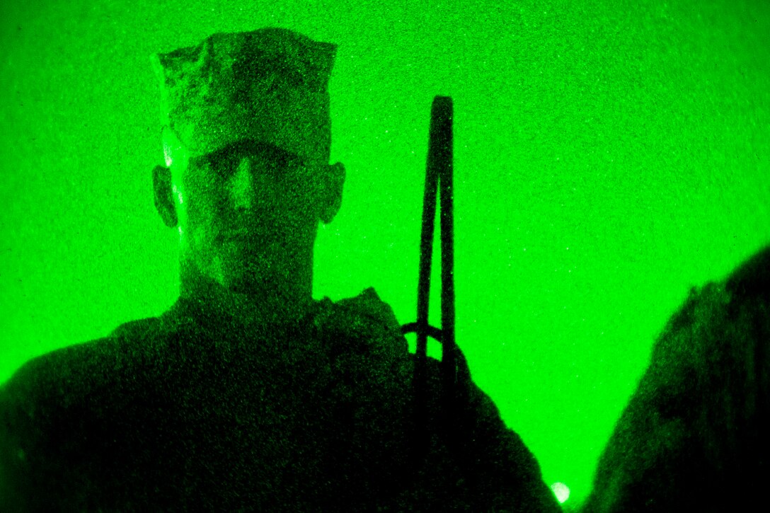 As seen through a night-vision device, U.S. Marine Corps 1st Lt. Mark Kratzer briefs his Marines after conducting mission rehearsals on Camp Leatherneck in Afghanistan's Helmand province, July 10, 2013. Kratzer is assigned to Golf Company, 2nd Battalion, 8th Marine Regiment.  
