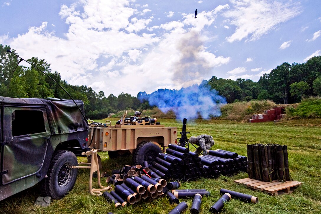 Soldiers fire a 120mm mortar during a training mission on Camp Atterbury, Ind., July 13, 2013. 
