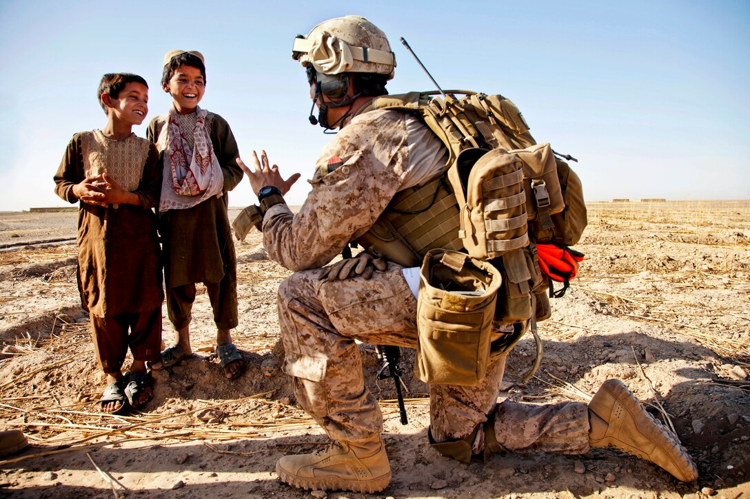 U.S. Marine Corps Capt. Bob J. Sise talks with Afghan children during Operation Northern Lion II in Helmand province, Afghanistan, July 3, 2013. Sise is assigned to Georgian Liaison Team 9.  

