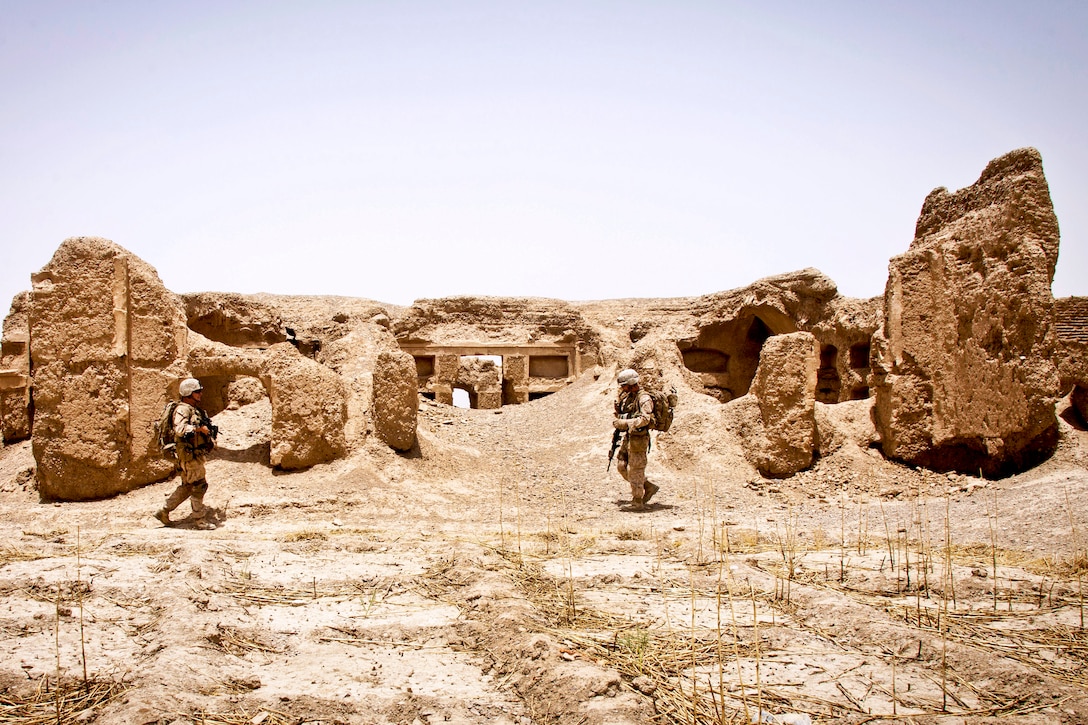 U.S. Navy Petty Officer 1st Class William Neason, left, and U.S. Marine Corps 1st Lt. Stephen T. Desmond, right, patrol through the ruins of a 200-year-old castle during Operation Northern Lion in Mohammad Abad village in Helmand province, Afghanistan, June 24, 2013. Neason, a hospital corpsman, and Desmond are assigned to Georgian Liaison Team-9.  
