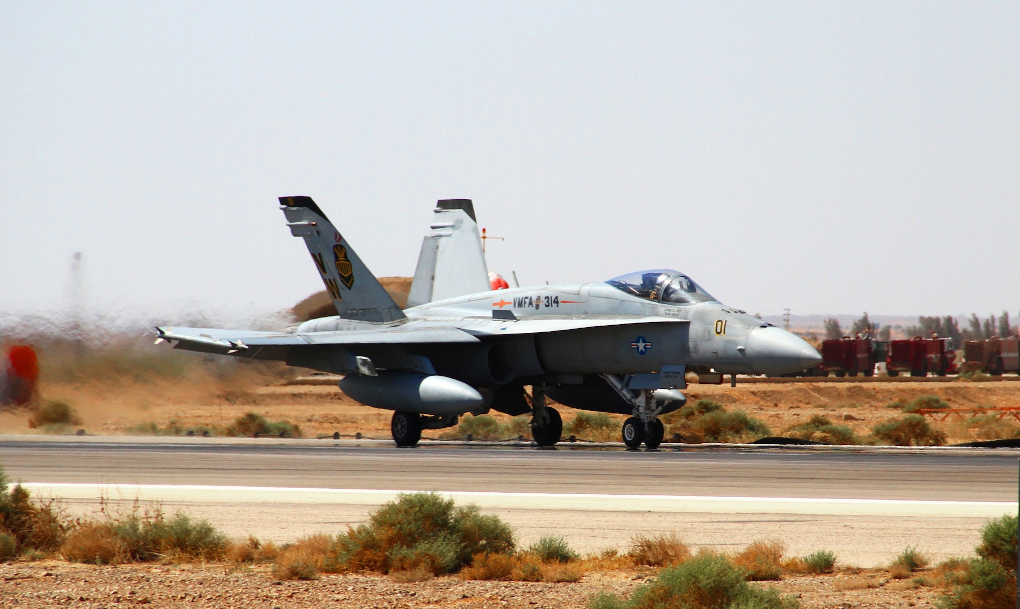 An F-18 Hornet from the U.S. Marine Corps Marine Air Group 50 taxis down a runway to join flying operations during Exercise Eager Tiger May 11, 2014, at an air base in northern Jordan. This exercise provides fighter pilots from the U.S. and Jordanian militaries a chance to conduct joint operations which enhance interoperability. (U.S. Air Force photo/Staff Sgt. Tyler McLain/Released)