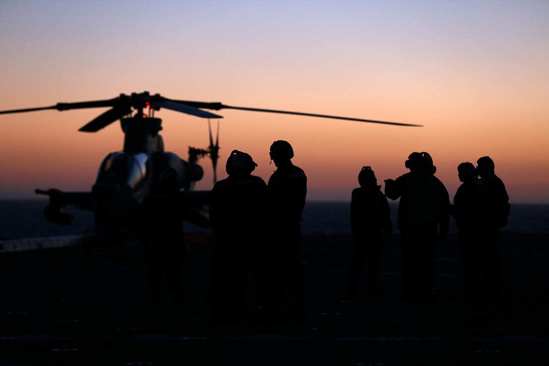 Marines with Marine Medium Tiltrotor Squadron 163 (Reinforced), 11th Marine Expeditionary Unit, and sailors with Amphibious Squadron (PHIBRON) 5, stand by to assist the take-off preparation of an AH-1Z Cobra during a take-off drill on the flight deck of the USS San Diego during Composite Training Unit Exercise (COMPTUEX) off the coast of San Diego, May 11, 2014. COMPTUEX serves as the second at-sea period for the 11th MEU, in which the unit will focus on the enabling and supporting functions necessary for success during full mission profile operations on the upcoming deployment. (U.S. Marine Corps photo by Gunnery Sgt. Rome M. Lazarus/Released)