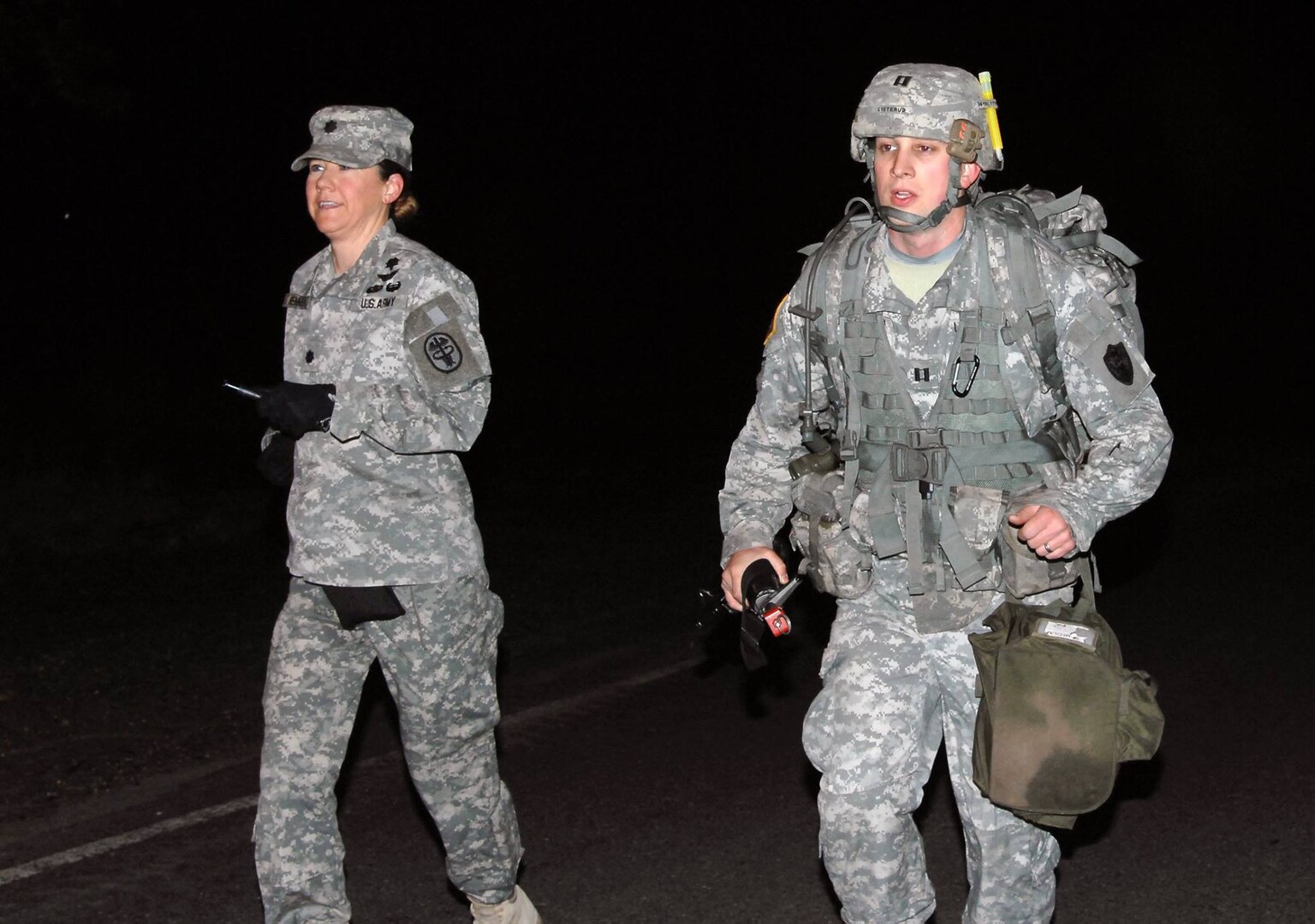 U.S. Army Capt. Bjorn Listerud, right, completes the 12-mile ruck march as part of qualification for the Expert Field Medical Badge. 