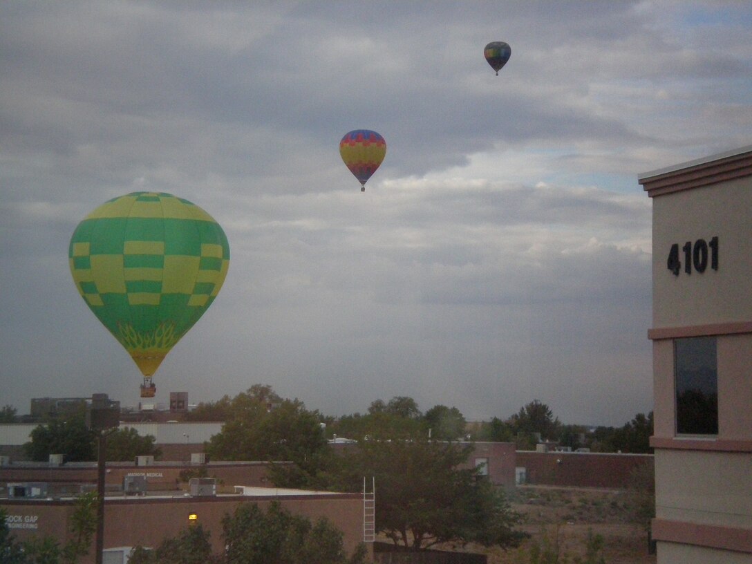 ALBUQUERQUE, N.M., – Three of the hundreds of hot air balloons from the Albuquerque Balloon Festival float near the District Office. Photo by Douglas Bailey, Oct. 4, 2011.