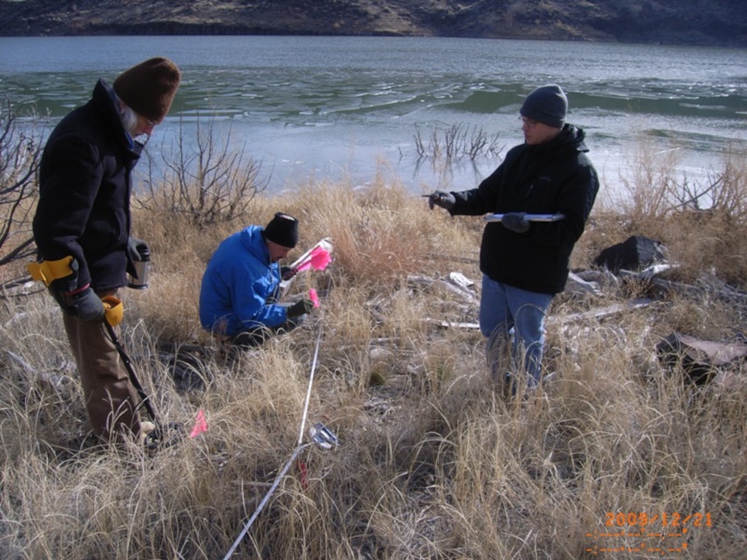 COCHITI LAKE, N.M., -- Albuquerque District archaeologists locate and measure artifact displacement from Cochiti Lake wave action as part of the Cochiti Deviation Artifact Movement Study.  The 5-year study is tracking the movement of "placed artifacts" due to lake water storage/wave action.
Photo by Greg Everhart, Dec. 21, 2009. 