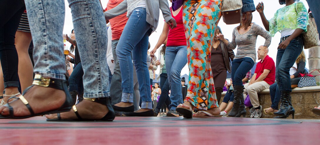 Marine spouses line-dance during a Military Spouse Appreciation Night at the Bob Hope Theater aboard Marine Corps Air Station Miramar, Calif., May 9. The celebration highlighted the homefront heroes of the air station and 3rd Marine Aircraft Wing. The event, hosted by Marine Corps Community Services, featured pampering and entertainment provided by local companies, followed by a stand-up comedy performance by the author of “Confessions of a Marine Wife,” Mollie Gross.