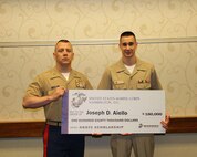 Capt. Matthew Lamb presents presents Joseph D. Aiello with an NROTC Scholarship check May 8 at Purdue university in Lafayette, Indiana. Capt. Lamb is the executive officer for Recruiting Station Indianapolis and attended to present Aiello the check.