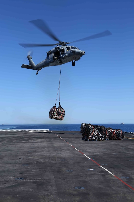 An MH-60S Knighthawk with Helicopter Sea Combat Squadron 23 (HSC-23) drops off cargo aboard the USS Makin Island flight deck as part of a re-supply during Composite Training Unit Exercise (COMPTUEX) off the coast of San Diego, May 12, 2014. COMPTUEX is the second at-sea event in the 11th Marine Expeditionary Unit and Makin Island Amphibious Ready Group joint predeployment training program, during which they will refine mission-related operations and blue-green communication. (U.S. Marine Corps photo by Lance Cpl. Laura Y. Raga/RELEASED)