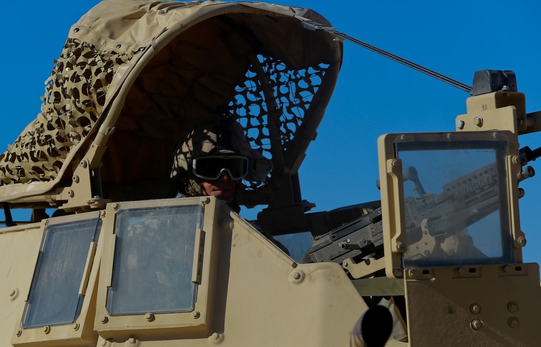 A Marine with Headquarters Battalion, 1st Marine Division, provides rear security for a convoy during Exercise Desert Scimitar at Marine Corps Air Ground Combat Center Twentynine Palms, Calif., May 10, 2014. The division tests and refines its capabilities by acting as the headquarters element of I Marine Expeditionary Force throughout a variety of scenarios and live-fire ranges. Large-scale exercises like Desert Scimitar leave 1st Marine Division poised to respond to different crises across the world. (U.S. Marine Corps photograph by Sgt. Timothy Lenzo/RELEASED)