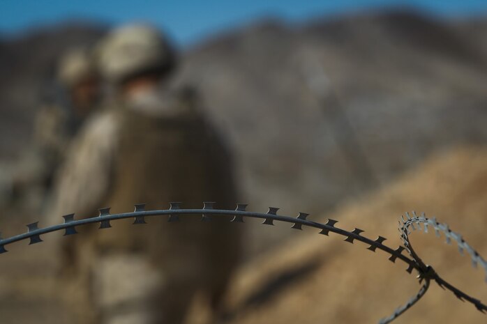 Marines with Headquarters Battalion, 1st Marine Division, leave friendly lines at the division entry control point during Exercise Desert Scimitar at Marine Corps Air Ground Combat Center Twentynine Palms, Calif., May 10, 2014. Desert Scimitar allows the division to test and refine its command and control capabilities by acting as the headquarters element of I Marine Expeditionary Force. The tough live-fire training that accompanies the exercise allows 1st Marine Division to meet possible real-world operational demands. (U.S. Marine Corps photograph by Sgt. Timothy Lenzo/RELEASED)