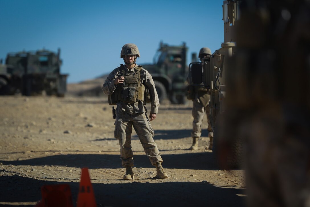 A Marine with Headquarters Battalion, 1st Marine Division, prepares to leave friendly lines with a convoy at the division entry control point during Exercise Desert Scimitar at Marine Corps Air Ground Combat Center Twentynine Palms, Calif., May 10, 2014. Desert Scimitar allows the division to test and refine its command and control capabilities by acting as the headquarters element of I Marine Expeditionary Force. The tough live-fire training that accompanies the exercise allows 1st Marine Division to meet possible real-world operational demands. (U.S. Marine Corps photograph by Sgt. Timothy Lenzo/RELEASED)