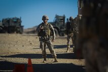 A Marine with Headquarters Battalion, 1st Marine Division, prepares to leave friendly lines with a convoy at the division entry control point during Exercise Desert Scimitar at Marine Corps Air Ground Combat Center Twentynine Palms, Calif., May 10, 2014. Desert Scimitar allows the division to test and refine its command and control capabilities by acting as the headquarters element of I Marine Expeditionary Force. The tough live-fire training that accompanies the exercise allows 1st Marine Division to meet possible real-world operational demands. (U.S. Marine Corps photograph by Sgt. Timothy Lenzo/RELEASED)