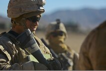 Lance Cpl. Carlos Salazar, a warehouse clerk with Headquarters Company, Headquarters Battalion, 1st Marine Division, stands guard at the division entry control point during Exercise Desert Scimitar at Marine Corps Air Ground Combat Center Twentynine Palms, Calif., May 10, 2014. It is not uncommon for Marines like Salazar, a native of Ft. Worth, Texas, to be called upon to maintain security during field training. 1st Marine Division acts as the headquarters element of I Marine Expeditionary Force during the exercise. (U.S. Marine Corps photograph by Sgt. Timothy Lenzo/RELEASED)