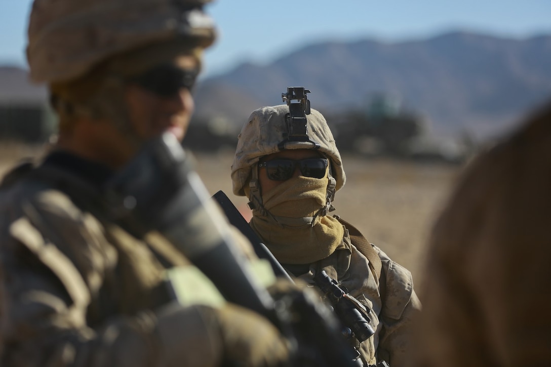 Corporal Solomon Salinas, right, a logistics embarkation specialist with Headquarters Company, Headquarters Battalion, 1st Marine Division, stands guard at the division entry control point during Exercise Desert Scimitar at Marine Corps Air Ground Combat Center Twentynine Palms, Calif., May 10, 2014. It is not uncommon for Marines like Salinas, a native of Houston, to be called upon to maintain security during field training. 1st Marine Division acts as the headquarters element of I Marine Expeditionary Force during the exercise. (U.S. Marine Corps photograph by Sgt. Timothy Lenzo/RELEASED)