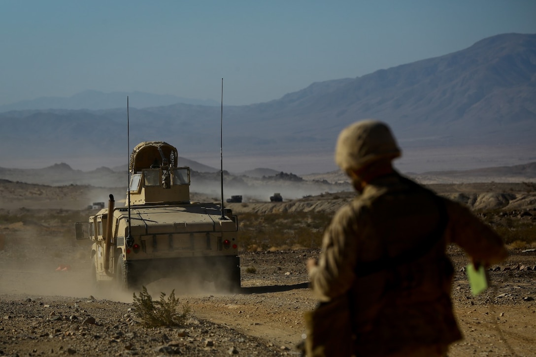 A Marine convoy with Headquarters Battalion, 1st Marine Division, leaves friendly lines during Exercise Desert Scimitar at Marine Corps Air Ground Combat Center Twentynine Palms, Calif., May 10, 2014. The division tests and refines its capabilities by acting as the headquarters element of I Marine Expeditionary Force throughout a variety of scenarios and live-fire ranges. Large-scale exercises like Desert Scimitar leave 1st Marine Division poised to respond to different crises across the world. (U.S. Marine Corps photograph by Sgt. Timothy Lenzo/RELEASED)