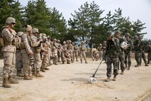 Republic of Korea Marines demonstrate a minesweeping technique for U.S. Marines April 21 during Korean Marine Exchange Program 14-6 in Pohang, Republic of Korea. Marines use metal detectors to help identify improvised explosive devices, landmines or anything potentially harmful that is buried underground. The ROK Marines are with the 1st ROK Marine Engineer Battalion, 1st ROK Marine Division.