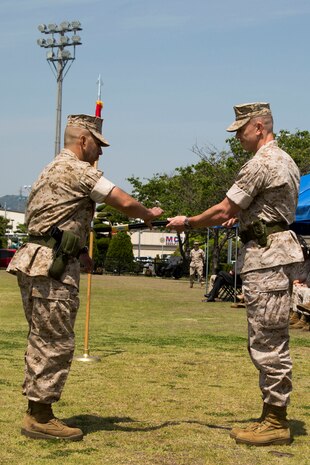 Sgt. Maj. Sergio MartinezRuiz, left, the newly appointed sergeant major for Marine Aircraft Group 12, takes control of the sword of office from Col. Hunter Hobson, the commanding officer for MAG-12, May 6, 2014, during a post and relief ceremony aboard Marine Corps Air Station Iwakuni, Japan. MartinezRuiz took the position as MAG-12 sergeant major after his tour as sergeant major for Marine Aviation Logistic Squadron 12.