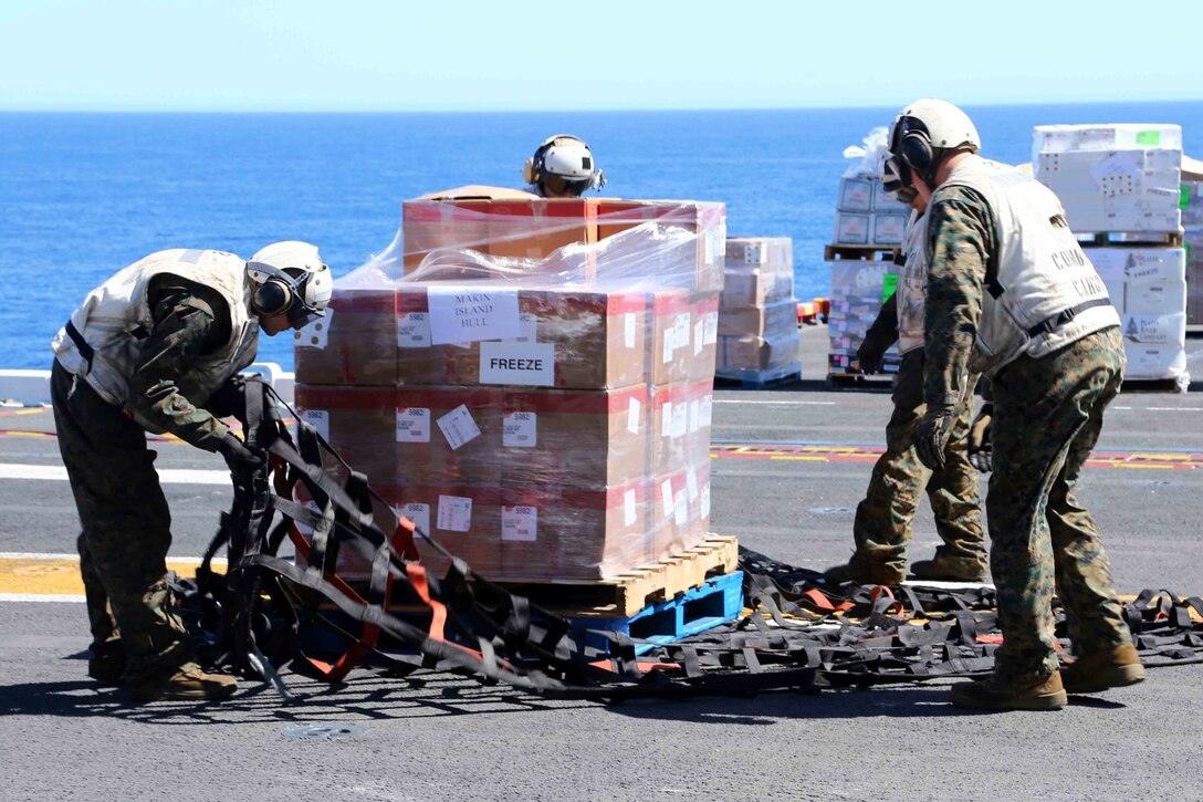 Marines with the 11th Marine Expeditionary Unit and sailors with the USS Makin Island, help conduct a re-supply during Composite Training Unit Exercise off the coast of San Diego, May 12, 2014. COMPTUEX serves as the second at-sea period for the 11th MEU, in which the unit will focus on the enabling and supporting functions necessary for success during full mission profiles operations during the upcoming deployment. (U.S. Marine Corps photo by Lance Cpl. Laura Y. Raga/RELEASED)