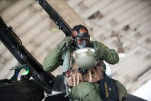 Lt. Col. Henry Jeffress, 80th Fighter Squadron director of operations, removes his mission oriented protective posture gear during exercise Beverly Bulldog 14-2 at Kunsan Air Base, Republic of Korea, May 9, 2014. This exercise tested the Wolf Pack's ability to perform its mission while under threat of chemical attack. (U.S. Air Force photo by Staff Sgt. Clayton Lenhardt/Released)