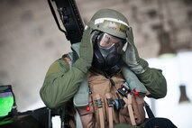 Lt. Col. Henry Jeffress, 80th Fighter Squadron director of operations, removes his mission oriented protective posture gear during exercise Beverly Bulldog 14-2 at Kunsan Air Base, Republic of Korea, May 9, 2014. This exercise tested the Wolf Pack's ability to perform its mission while under threat of chemical attack. (U.S. Air Force photo by Staff Sgt. Clayton Lenhardt/Released)