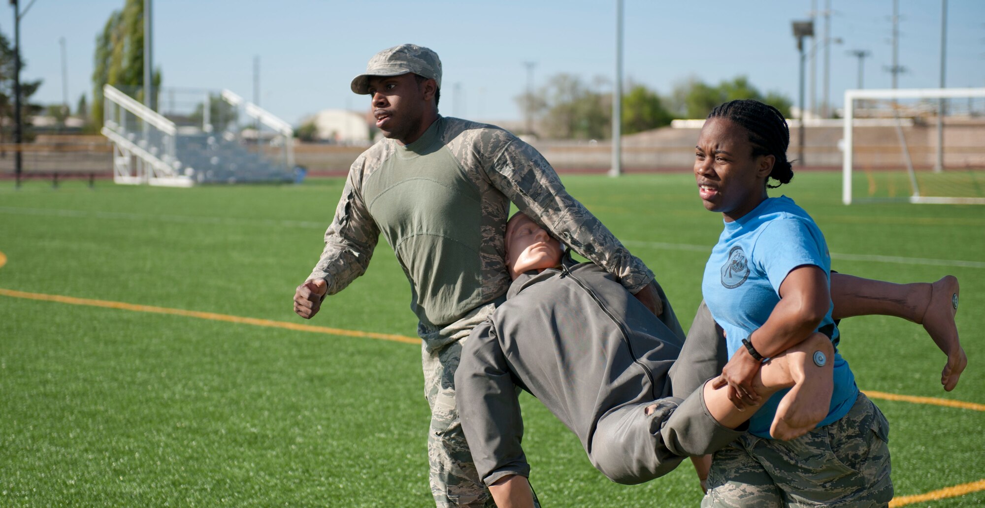 Staff Sgt. Barrett Johnson, 366th Fighter Wing Judge Advocate adverse actions paralegal, and Airman 1st Class Autumn Amador, 366th Fighter Wing JA courts martial paralegal, carries a dummy during the Defender’s Challenge May 13, 2014, at Mountain Home Air Force Base, Idaho. May 12-16 marks the 2014 Police Week, a national week celebrating U.S. police forces. (U.S. Air Force photo by Airman 1st Class Malissa Lott/RELEASED)