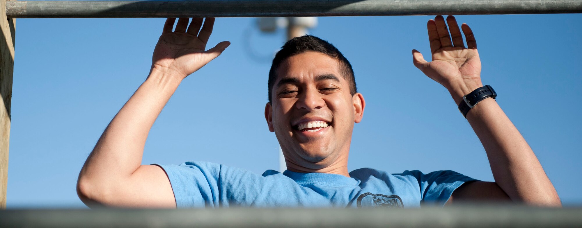 Capt. Andy Tan, 366th Fighter Wing Judge Advocate chief of civil law, jumps to do a pull up during the 2014 Police Week Defender’s Challenge May 13, 2014, at Mountain Home Air Force Base, Idaho. During National Police Week, different challenges and events are available for Gunfighters to show their support to their Defenders. (U.S. Air Force photo by Airman 1st Class Malissa Lott/RELEASED)
