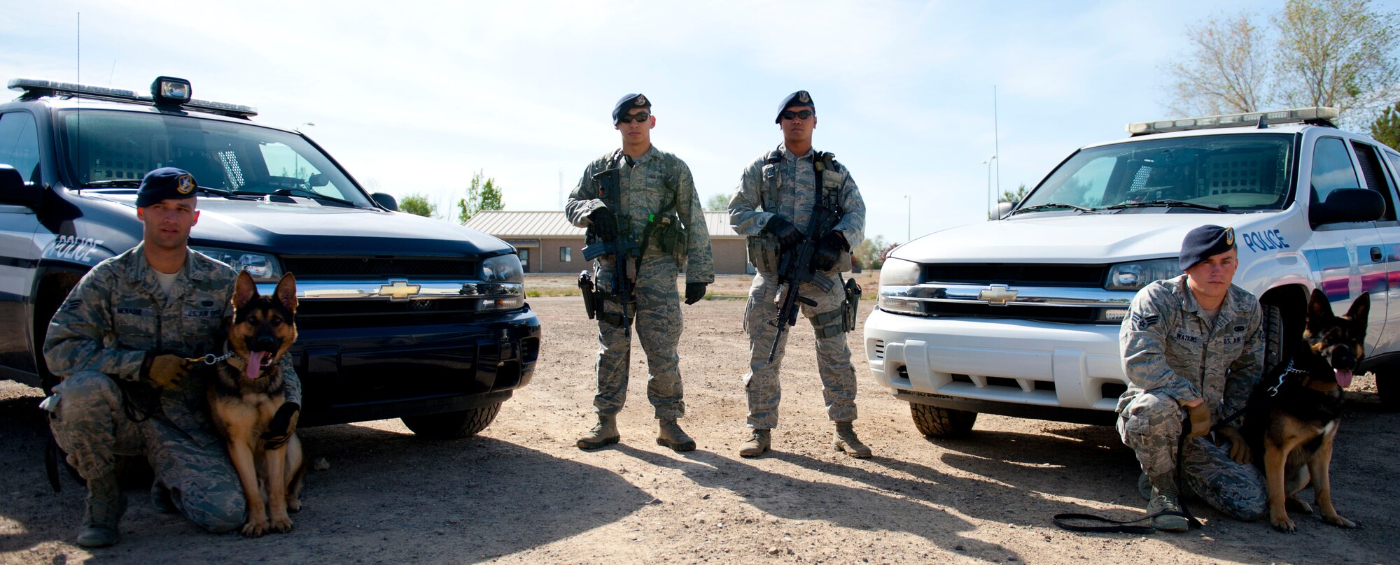 (From left to right): Senior Airman Scott Menadue, 366th Security Forces Squadron Military Working Dog handler, Staff Sgt. Lucas Medelez, 366th SFS response force leader, Senior Airman Matthew Beall, 366th SFS response force member, and Senior Airman Steven Watkins, 366th SFS MWD handler, pose for a photo after the Defender’s Challenge, May 13, 2014, at Mountain Home Air Force Base, Idaho. During Police Week, various events will be open for Airmen to support their Defenders. (U.S. Air Force photo by Airman 1st Class Malissa Lott/RELEASED))