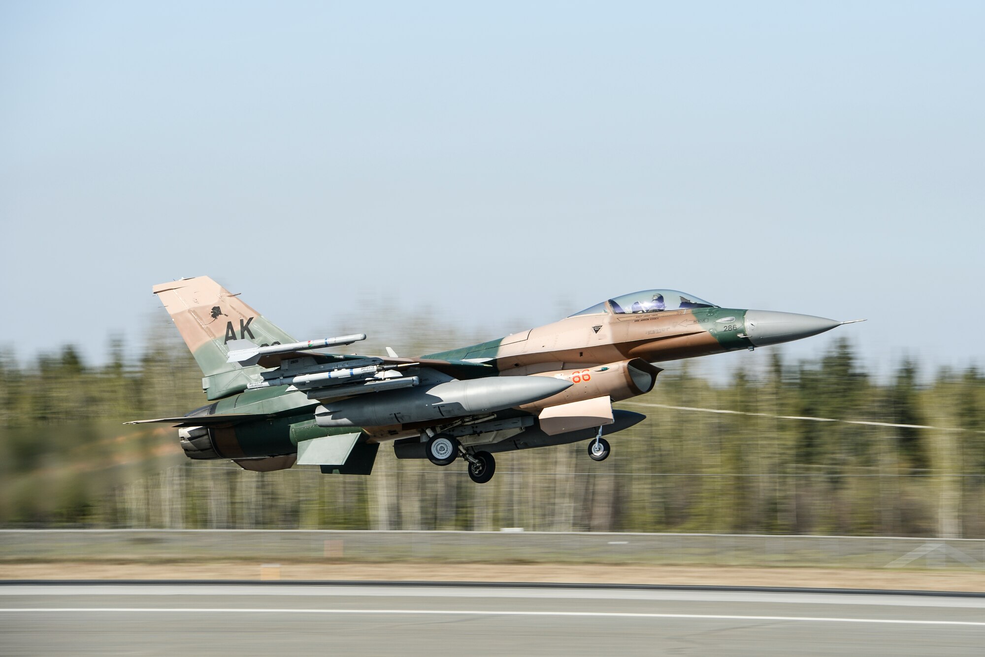 A U.S. Air Force F-16 Fighting Falcon assigned to the 18th Aggressor Squadron takes off during RED FLAG-Alaska 14-1 May 12, 2014, Eielson Air Force Base, Alaska. The exercise enables allied nations to test their operational capability in a simulated deployed environment. (U.S. photo by Senior Airman Peter Reft/Released)
