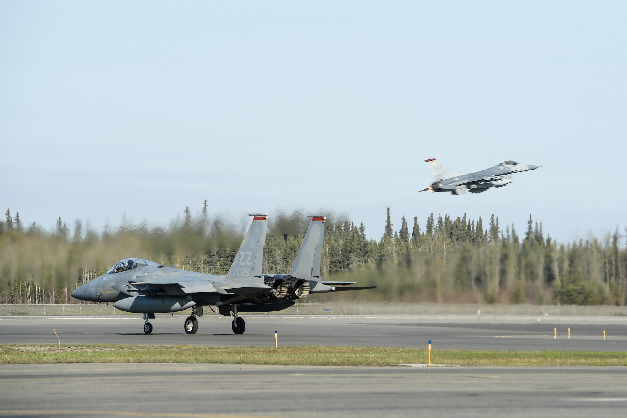 A U.S. Air Force F-15 Eagle assigned to the 67th Fighter Squadron, Kadena Air Base, Japan, and a Republic of Singapore Air Force F-16 Fighting Falcon assigned to the 425th Fighter Squadron, Luke Air Force Base, Ariz., taxi and take off for a sortie during RED FLAG-Alaska 14-1 May 12, 2014, Eielson Air Force Base, Alaska.  RF-A provides allied pilots, aircrew and operational support personnel with a training area of more than 65,000 square miles. (U.S. photo by Senior Airman Peter Reft/Released)