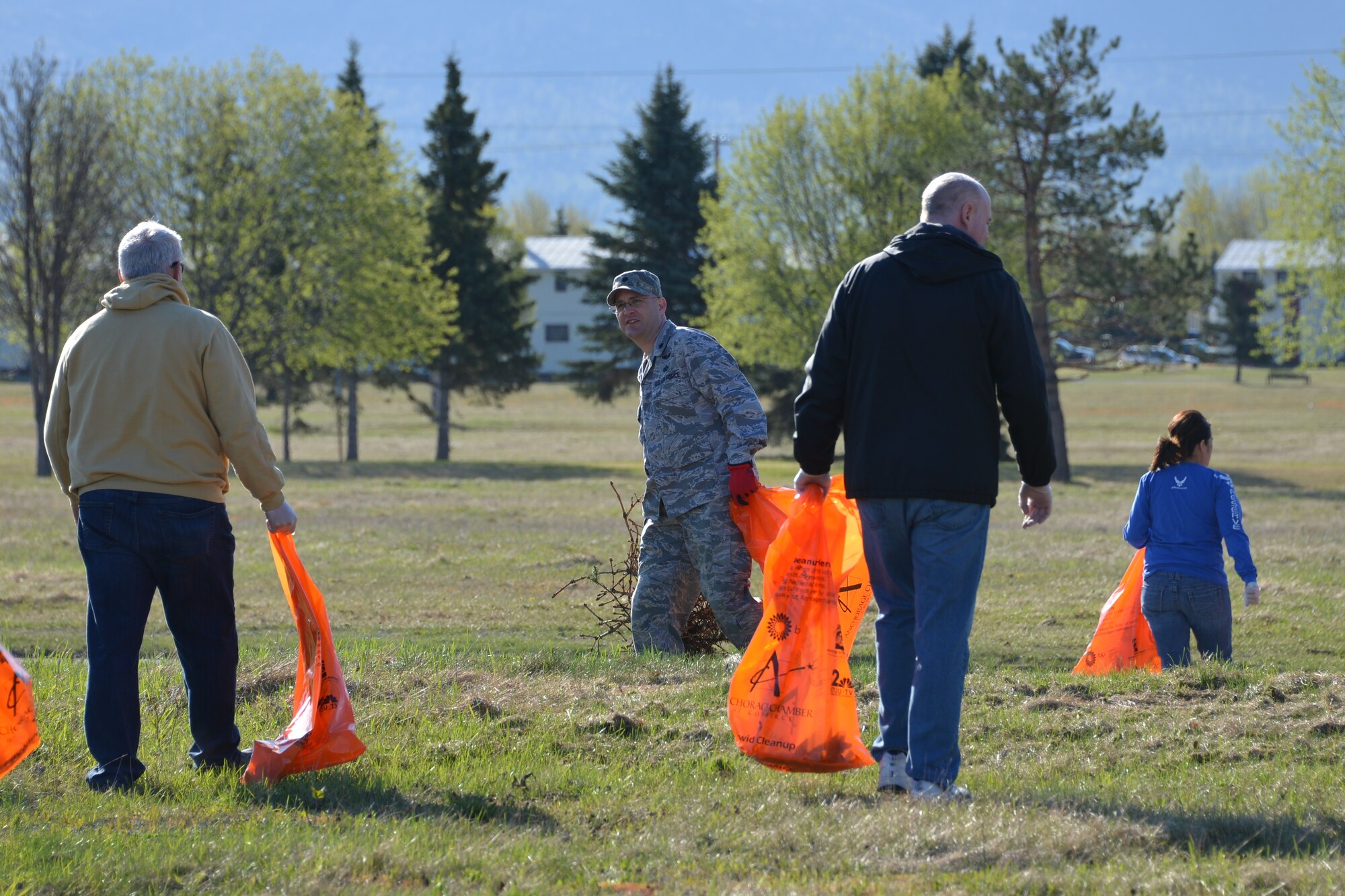 Lt. Col. Dave Kurle, 477th Force Support Squadron commander, collects trash with members of the 477th FG during the Anchorage Chamber of Commerce city wide clean up May 9. (U.S. Air Force/Capt. Ashley Conner)