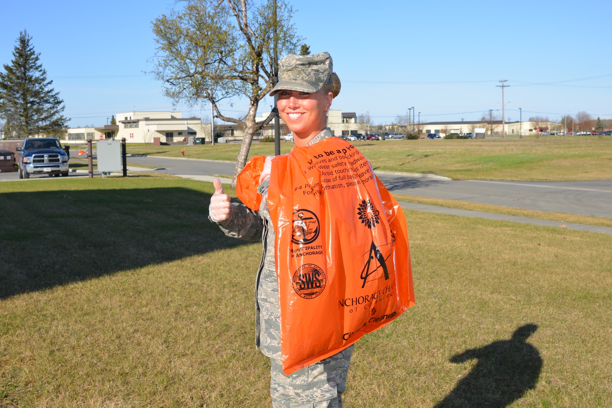 Senior Airman Carly Chase, 477th FSS, gives a thumbs up to a cleaner Alaska during the Anchorage Chamber of Commerce citywide cleanup May 9. (U.S. Air Force/Capt. Ashley Conner)