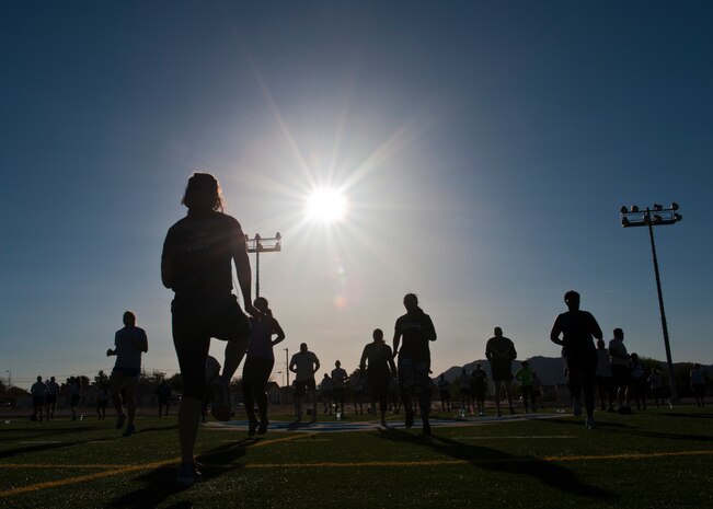 Participants warm-up before the Warrior Trained Fitness exercise session at the Warrior Fitness Center May 13, 2014, at Nellis Air Force Base, Nev. WTF is a high intensity workout meant to increase cardio-vascular fitness and muscular strength. (U.S. Air Force photo by Airman 1st Class Thomas Spangler)