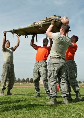 The Combat Search and Rescue Combined Test Force team lifts a mannequin over their heads during the 99th Medical Group’s Life of a Warrior Challenge May 9, 2014 at Nellis Air Force Base, Nev. Teams were tasked with lifting the litter 100 times before continuing on to the next stage of the challenge. (U.S. Air Force photo by Senior Airman Timothy Young)