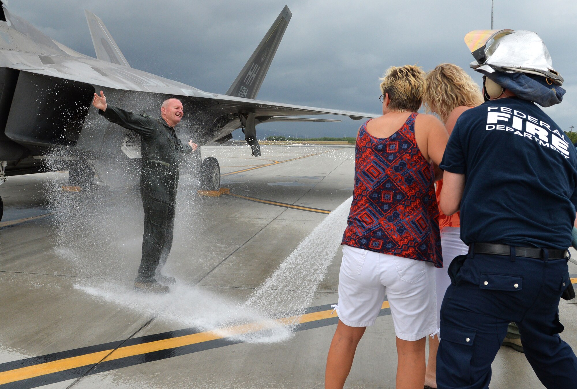 Col. Terry Scott, 15th Wing vice commander, is hosed down after a training mission at Joint Base Pearl Harbor-Hickam, Hawaii, May 9, 2014. The mission was Scott’s “fini-flight,” a ceremonial final flight for Air Force pilots. Scott is retiring after 33 years of enlisted and commissioned service.  (U.S. Air Force photo/Staff Sgt. Alexander Martinez)