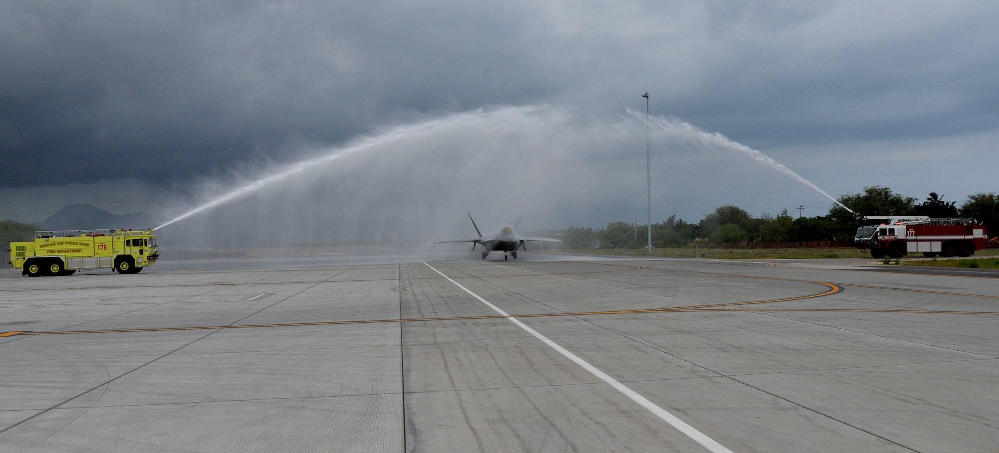 An F-22 Raptor controlled by Col. Terry Scott, 15th Wing vice commander, passes under  a shower of water after a training mission at Joint Base Pearl Harbor-Hickam, Hawaii, May 9, 2014. The mission was Scott’s “fini-flight,” a ceremonial final flight for Air Force pilots. Scott is retiring after 33 years of enlisted and commissioned service. (U.S. Air Force photo/Staff Sgt. Alexander Martinez) 