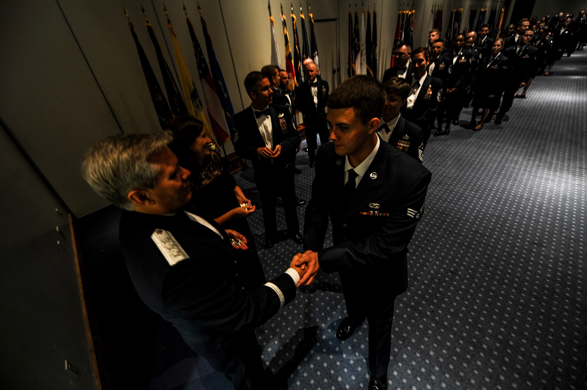 Lt. Gen. Eric Fiel, Air Force Special Operations Command commander, coins enlisted Airmen after an Order of the Sword ceremony at the Emerald Coast Convention Center in Fort Walton Beach, Fla., May 9, 2014. Fiel was the ninth officer inducted into AFSOC’s Order of the Sword. (U.S. Air Force photo/Senior Airman Christopher Callaway) 