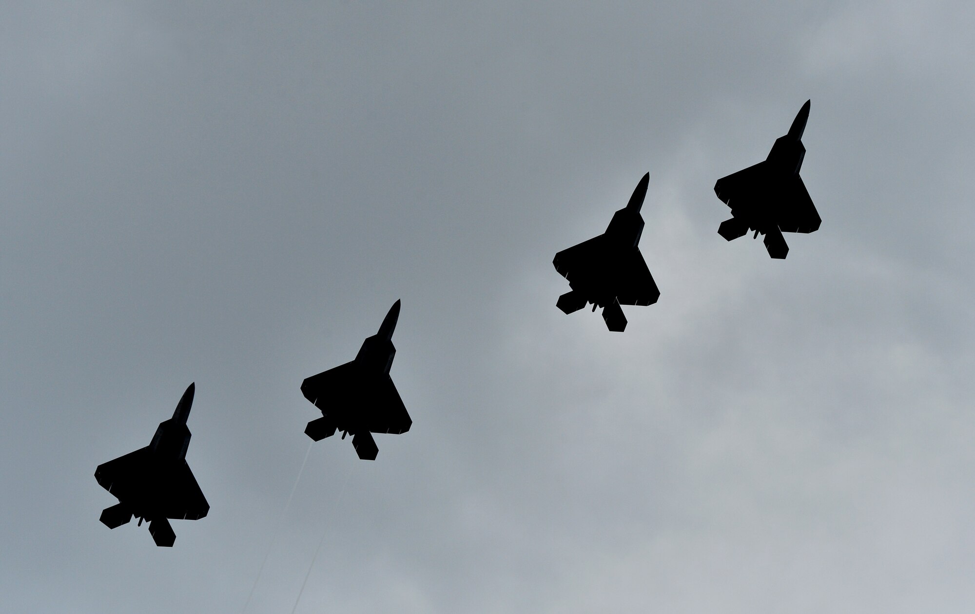 Four F-22 Raptors fly in formation during a training exercise above Joint Base Pearl Harbor-Hickam, Hawaii, May 9, 2014. Col. Terry Scott, 15th Wing vice commander, is one of the pilots in the mission. The mission was Scott’s “fini-flight,” a ceremonial final flight for Air Force pilots. Scott is retiring after 33 years of enlisted and commissioned service. (U.S. Air Force photo/Staff Sgt. Alexander Martinez)
