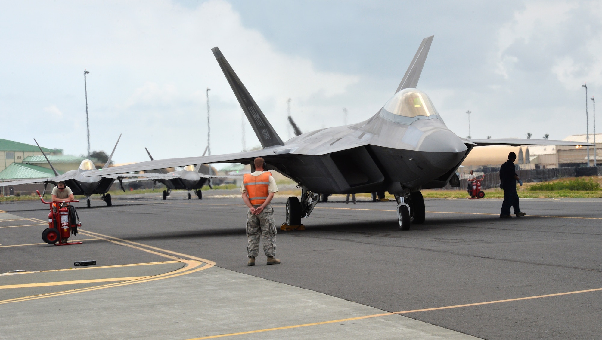 An F-22 Raptor controlled by Col. Terry Scott, 15th Wing vice commander, receives its final inspection before a training mission at Joint Base Pearl Harbor-Hickam, Hawaii, May 9, 2014. The mission was Scott’s “fini-flight,” a ceremonial final flight for Air Force pilots. Scott is retiring after 33 years of enlisted and commissioned service. (U.S. Air Force photo/Staff Sgt. Alexander Martinez)