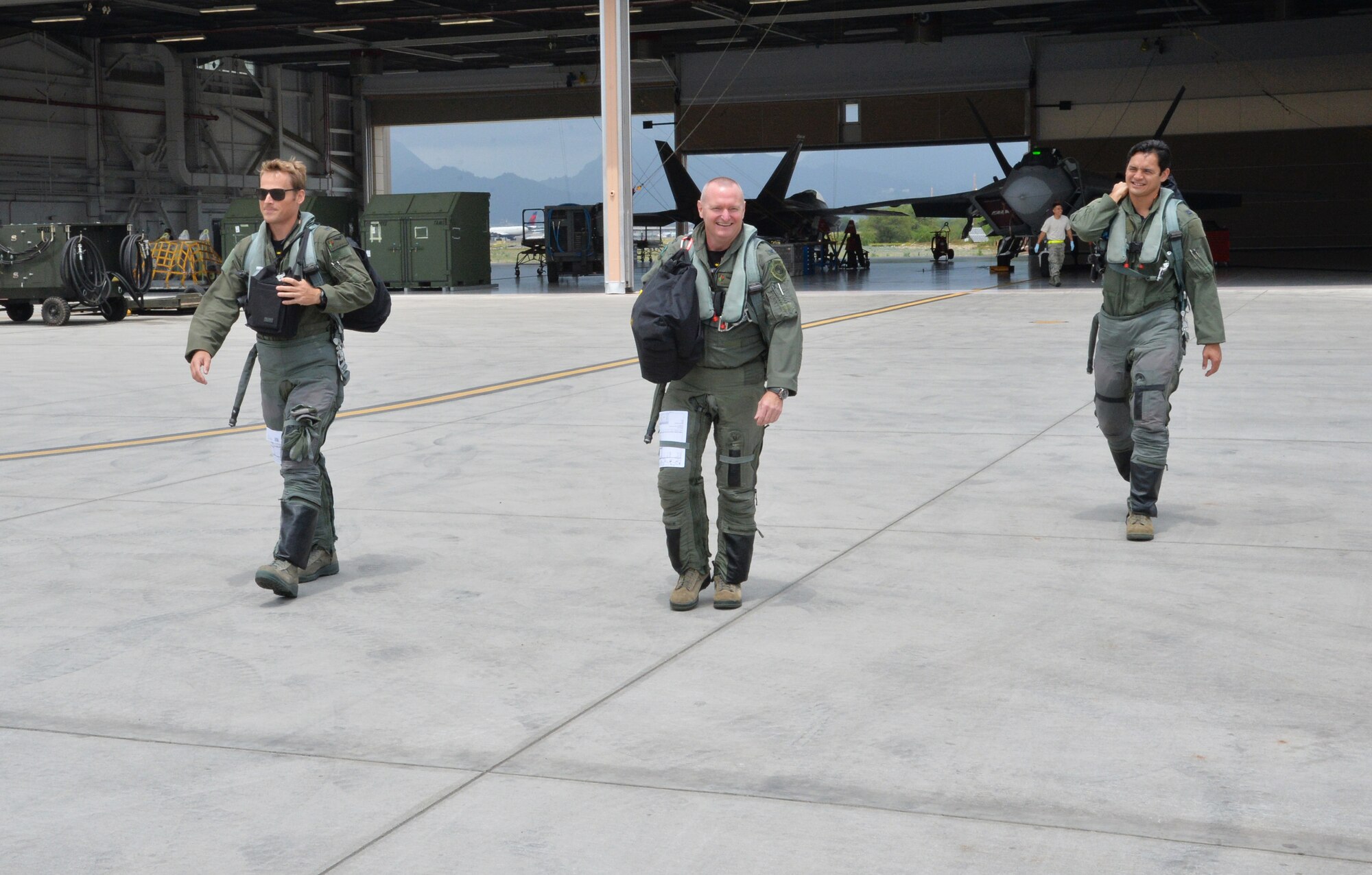From left: 1st Lt. Austin McIntosh, 19th Fighter Squadron, Col. Terry Scott, 15th Wing vice commander and Capt. Vaimana Conner, 19th FS, prepare to fly a training mission aboard F-22 Raptors during Scott’s final career flight at Joint Base Pearl Harbor-Hickam, Hawaii, May 9, 2014. A pilot’s final flight, or “fini-flight,” is a farewell tradition for Air Force pilots. Scott is retiring after 33 years of enlisted and commissioned service. (U.S. Air Force photo/Staff Sgt. Alexander Martinez)