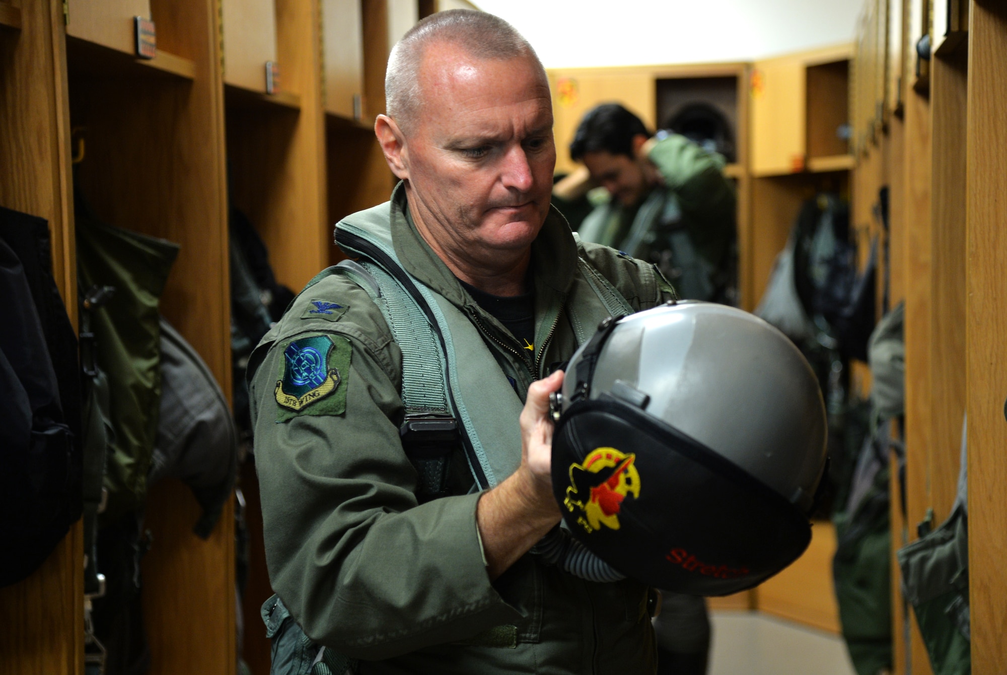 Col. Terry Scott, 15th Wing vice commander, suits up for his final mission as an F-22 Raptor instructor pilot at Joint Base Pearl Harbor-Hickam, Hawaii, May 9, 2014. The mission was Scott’s “fini-flight,” a ceremonial final flight for Air Force pilots. Scott is retiring after 33 years of enlisted and commissioned service. (U.S. Air Force photo/Staff Sgt. Alexander Martinez)