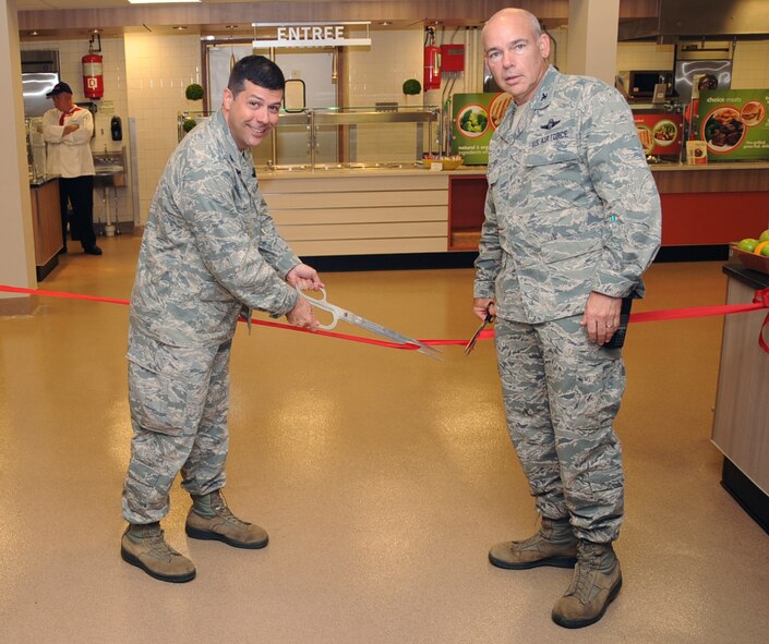 Col. Andrew Gebara, left, 2nd Bomb Wing commander, and Col. Patrick Matthews, 2nd Mission Support Group commander, cut a ribbon signifying the re-opening of the Red River Dining Facility on Barksdale Air Force Base, La., May 13, 2014. The dining facility will be open Monday through Friday from 6 a.m. to 9 a.m. for breakfast, 10:30 a.m. to 1:30 p.m. for lunch, 4:30 p.m. to 6:30 p.m. for dinner and 11 p.m. to 1:30 a.m. for a midnight meal. (U.S. Air Force photo/Staff Sgt. Sean Martin)