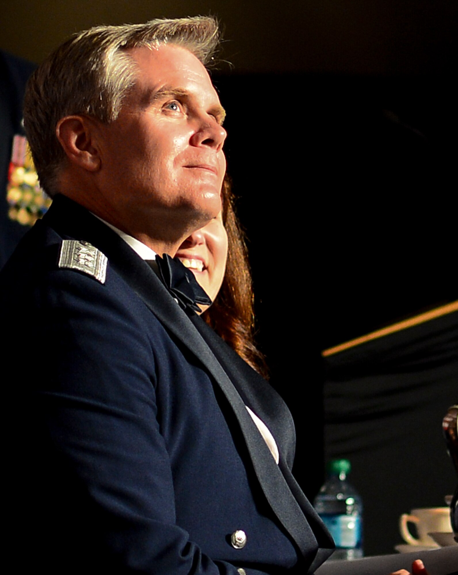 Lt. Gen. Eric Fiel, Air Force Special Operations Command commander, listens to Chief Master Sgt. of the Air Force James Cody speak at the Emerald Coast Convention Center in Fort Walton Beach, Fla., May 9, 2014. More than 500 enlisted Airmen honored Fiel at his Order of the Sword ceremony. (U.S. Air Force photo/Airman 1st Class Jeff Parkinson)