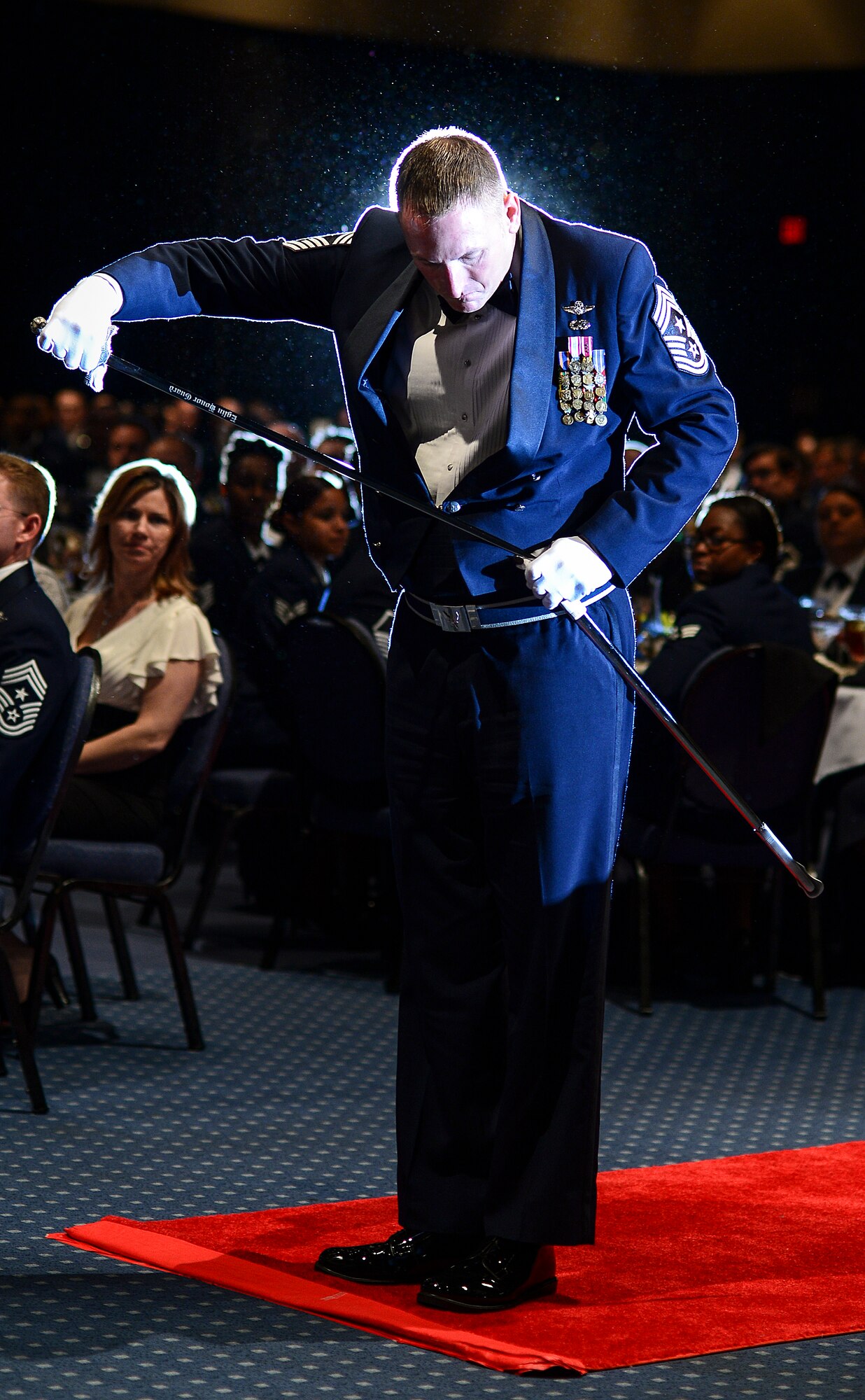 Chief Master Sgt. Paul Henderson, 27th Special Operations Wing command chief, sheaths his sword at the Emerald Coast Convention Center in Fort Walton Beach, Fla., May 9, 2014. More than 500 enlisted Airmen honored Lt. Gen. Eric Fiel, Air Force Special Operations Command commander, at his Order of the Sword ceremony. (U.S. Air Force photo/Airman 1st Class Jeff Parkinson)