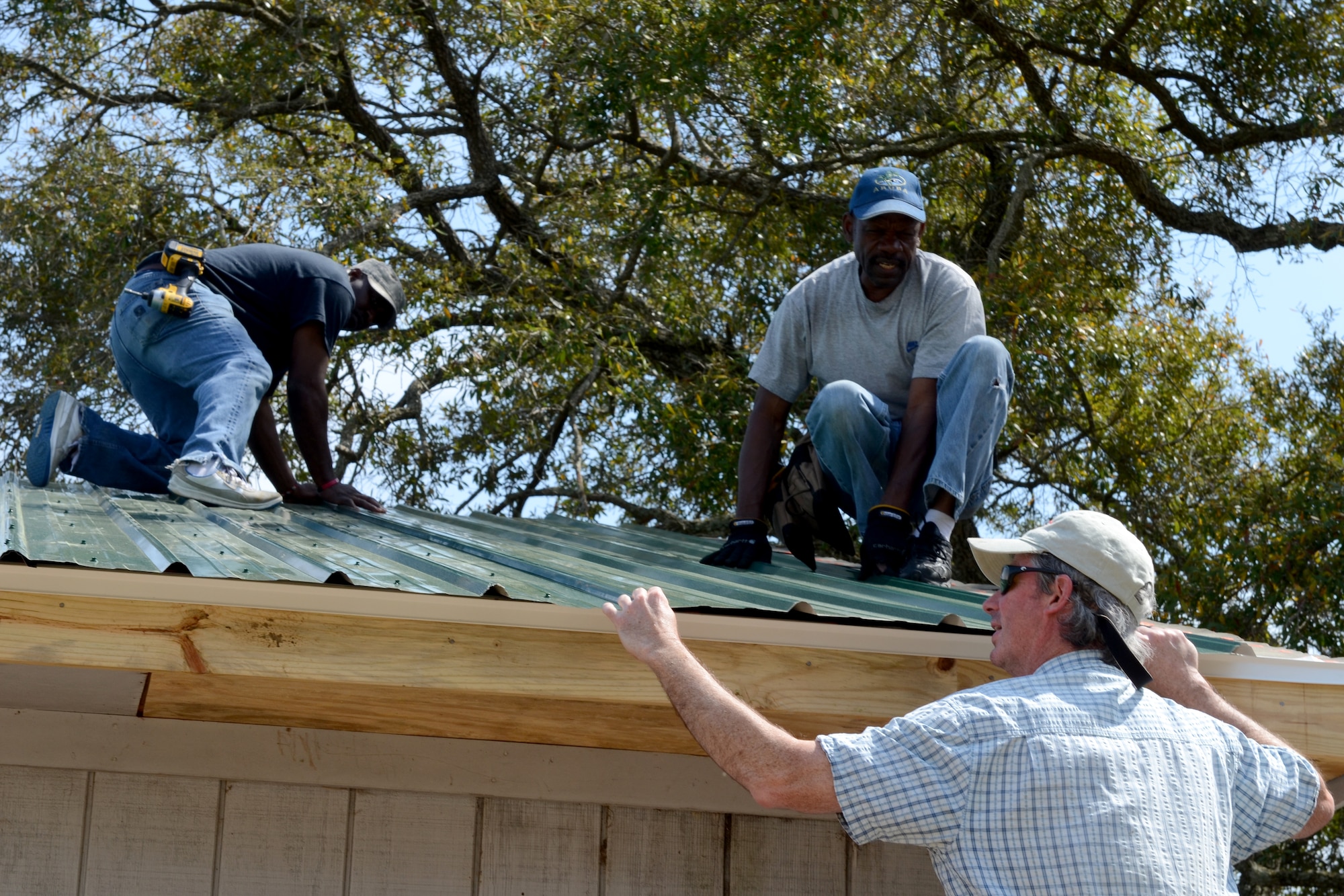 South Carolina State employees from McEntire Joint National Guard Base replace the roof on the base pavilion facility at the base pond site, April 3, 2014. (U.S. Air National Guard photo by Senior Master Sgt. Edward Snyder/Released)