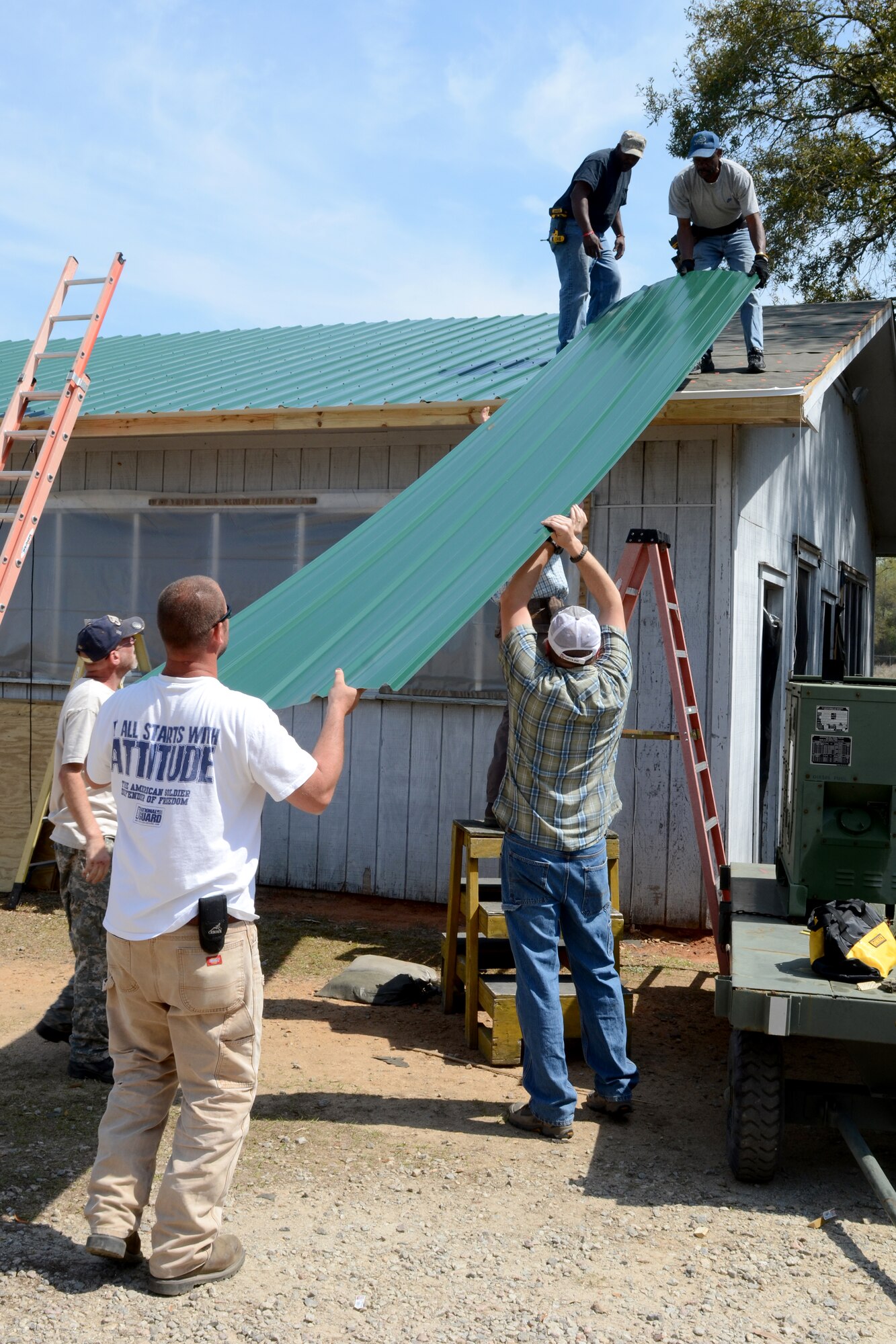 South Carolina State employees from McEntire Joint National Guard Base replace the roof on the base pavilion facility at the base pond site, April 3, 2014. (U.S. Air National Guard photo by Senior Master Sgt. Edward Snyder/Released)