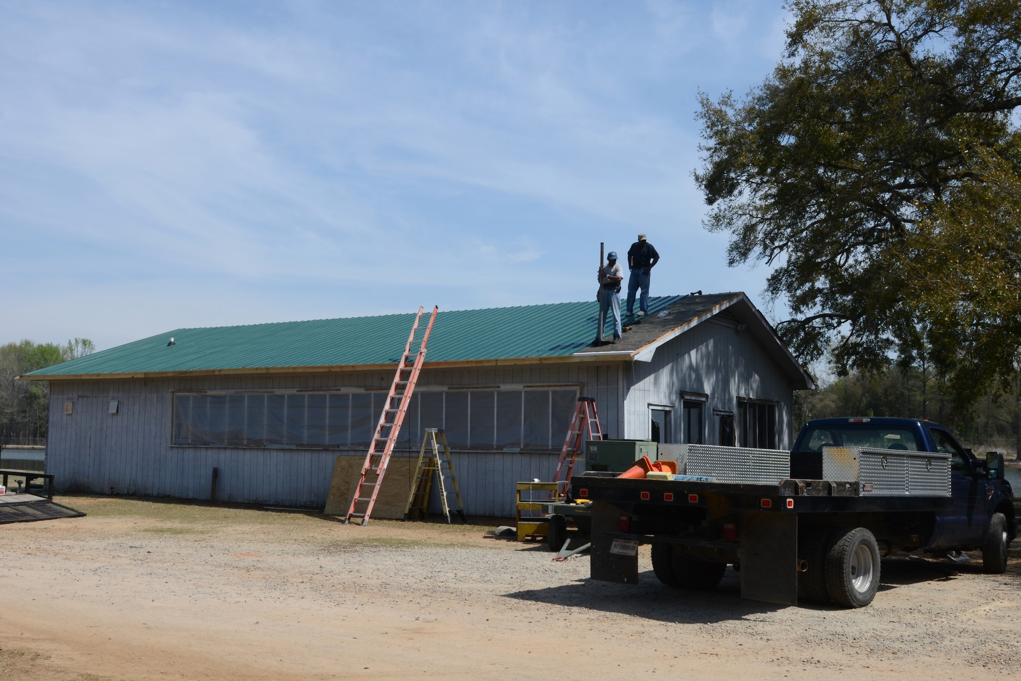 South Carolina State employees from McEntire Joint National Guard Base replace the roof on the base pavilion facility at the base pond site, April 3, 2014. (U.S. Air National Guard photo by Senior Master Sgt. Edward Snyder/Released)